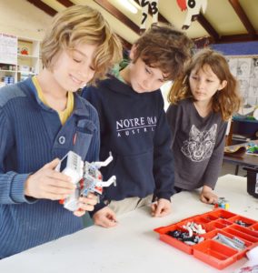 Year 6 students Billy Freeman, Sholto Armstrong and Nava Wilson-Mirzaei construct a robot.